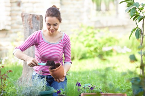 Gardener assisting a customer with mobility needs in a backyard